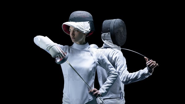 Portrait of two fencers on a black background. The concept of fencing. Duel.