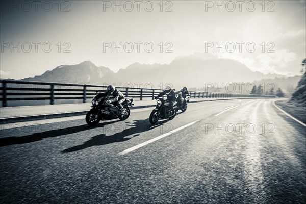 Three motorcyclists on the Rossfeld panoramic road with the Hoher Goell in the background