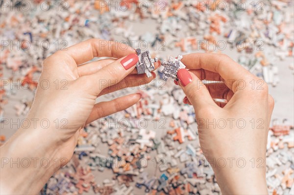 Woman arranges puzzles. Board game concept. Stay at home.
