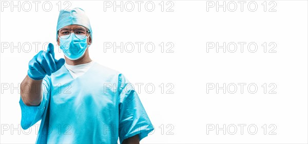 Portrait of a doctor on a white background. He points a finger at the camera. Medicine concept.