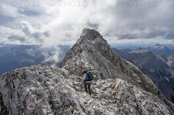 Mountaineer on a narrow rocky ridge