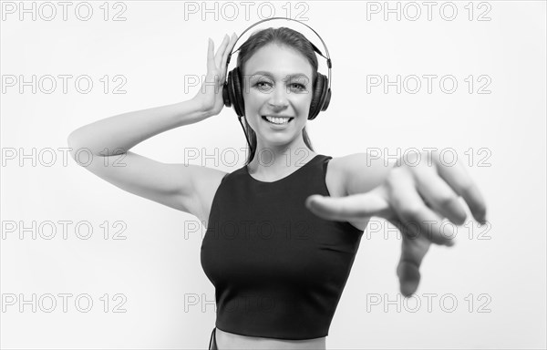 Portrait of a woman in professional headphones. White background. Dj concept.