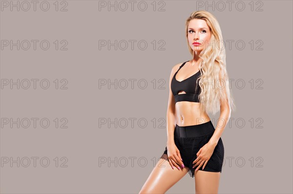 Charming sports girl posing in sportswear.