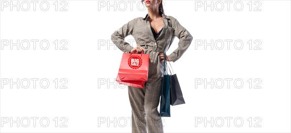 Stylish tall woman posing with packages. No name. White background. Concept for discounts