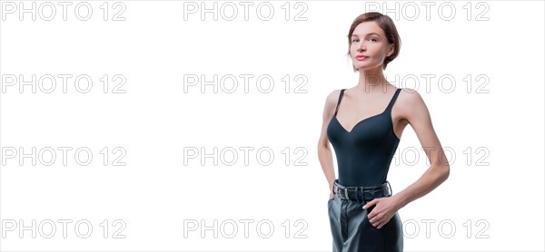 Portrait of a beautiful tall slender woman. She is posing in the studio on a white background. Concept of style and a beautiful figure