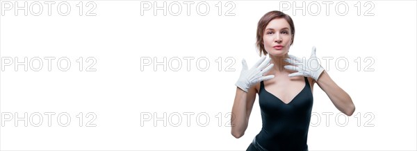 Surprised beautiful young woman in white gloves posing in the studio on a white background.