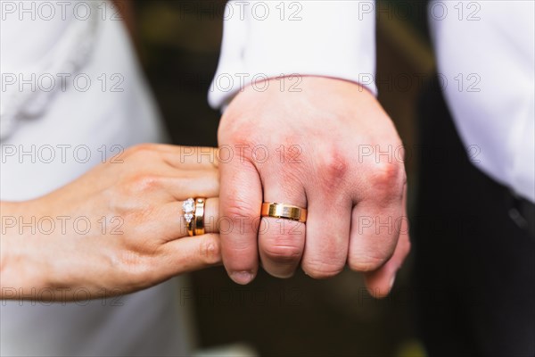 Detail of hands of bride and groom with rings at a wedding