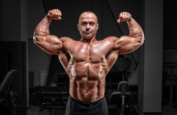 Professional weightlifter posing in the gym. Classic bodybuilding.