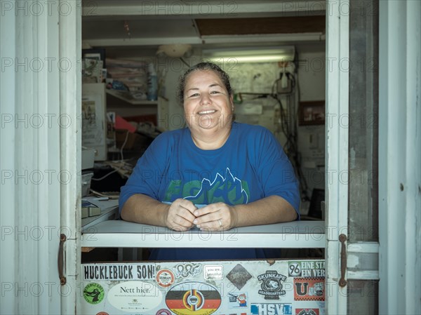 Employee at the counter of the Ochopee Post Office