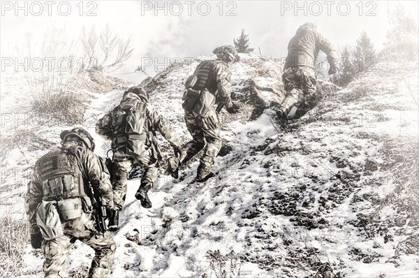 Group of special forces climbs into the mountains in order to take a favorable position to protect the target.