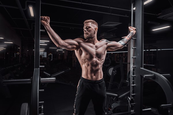 Portrait of an athlete in a special ramp in the gym. Bodybuilding and fitness concept.