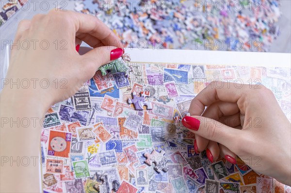 Teenager plays puzzles. The concept of board educational games. Stay at home.