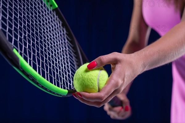 Image of a tennis ball on the background of the strings of the racket. Sports concept.