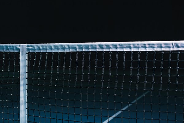 Image of a tennis court with a stretched net. Sports concept.