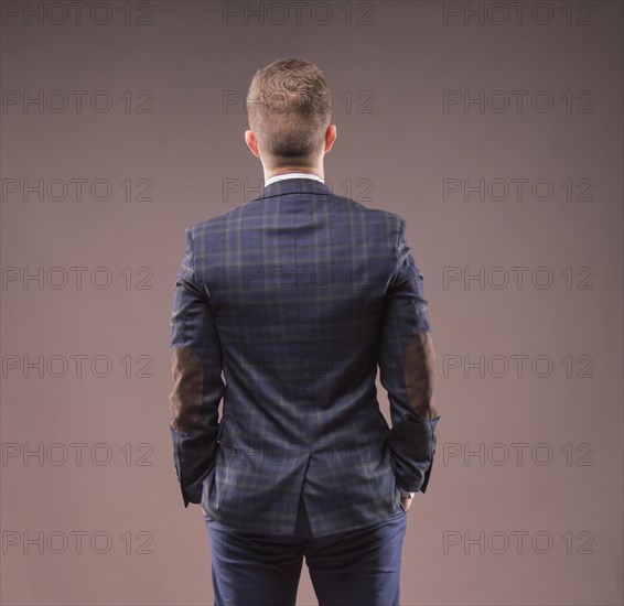 Man stands with his back to the camera and looking at something