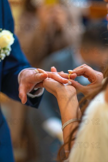 Bride about to put the ring on the groom at a beautiful wedding