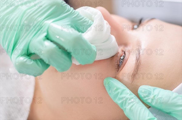 Beautiful girl gets face peeling. Skin health concept. Beauty salons.