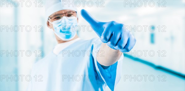 The doctor in the medical center shows a raised finger. Medicine concept.