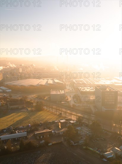 The city awakes in the morning light with a water tower as a central element