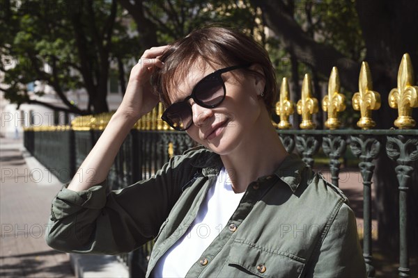 Portrait of a stylish woman in sunglasses. Happiness