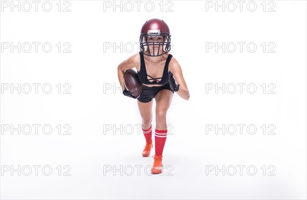 Woman in the uniform of an American football team player posing on a white background. Sports concept.