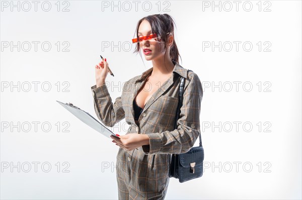 Charming young girl answers the test questions. White background. University admission concept.