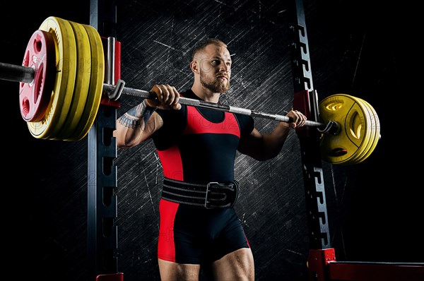 Professional athlete prepares to squat with a barbell.