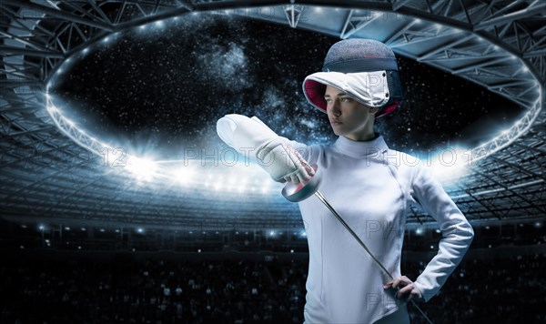 Portrait of a fencer against the backdrop of a sports arena. The concept of fencing.