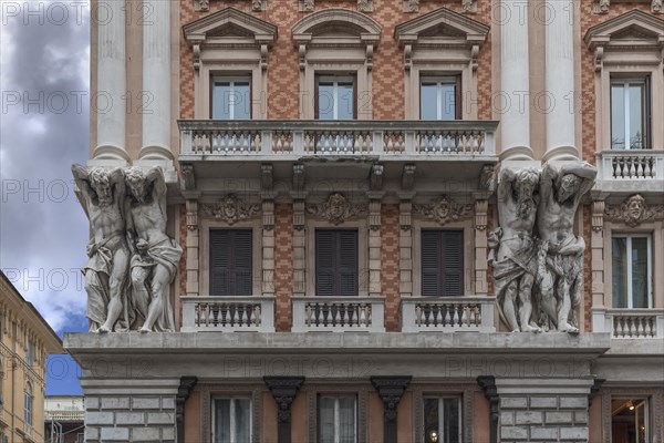 Four atlases on a historic house facade