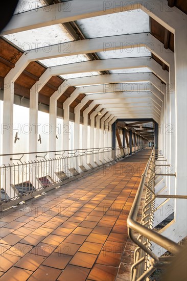 Perspective view of a corridor with concrete structure and side railings