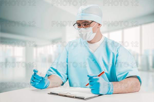 The doctor looks at the jar of pills and writes out a prescription. Medicine concept.