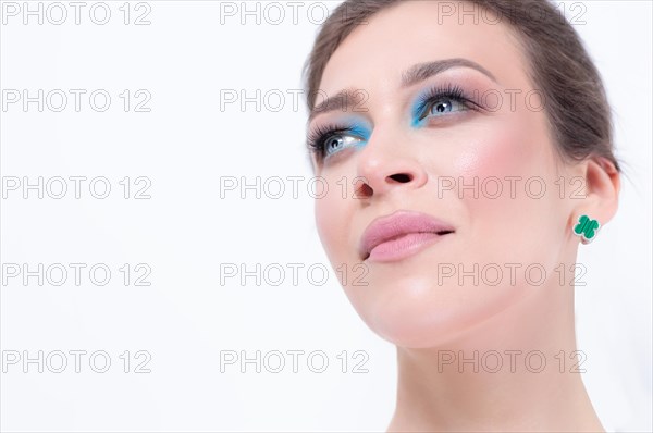 Portrait of a beautiful girl with a defiant make-up. White background. Beauty concept. High quality