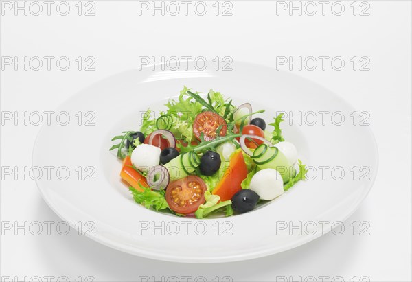 Classic greek salad. Top view. White background. Healthy eating concept.