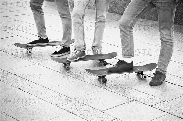 Group of skateboarders are standing near their boards and are preparing to begin training