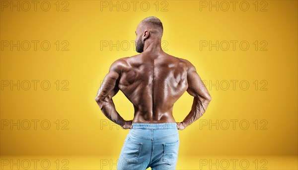 Isolated professional sportsman on a yellow background. Bodybuilding concept. Panorama. Advertising of a gym and sports nutrition.