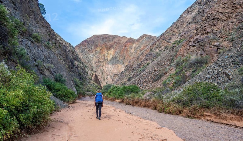 Climber in a canyon with a dry stream bed - Photo12-imageBROKER-Moritz Wolf