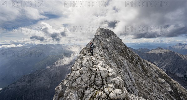 Mountaineer on a narrow rocky ridge