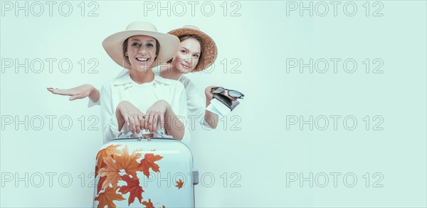 Portrait of two smiling women with passports