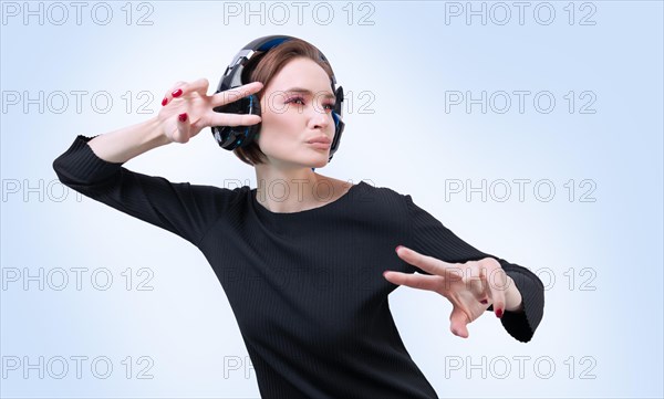 Portrait of a woman in professional headphones. White background. Dj concept.