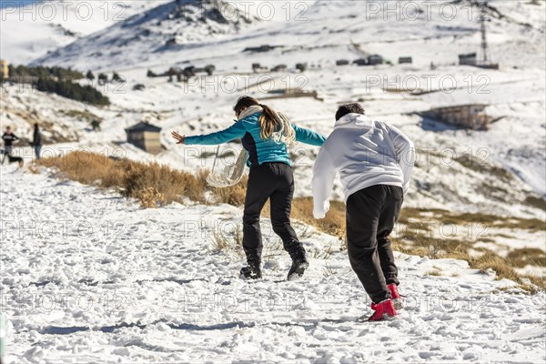 Icy adventures await! A Latino family revels in the snowy hills of Sierra Nevada