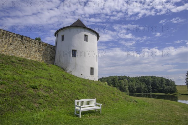 Tower of the fortified village and white bench