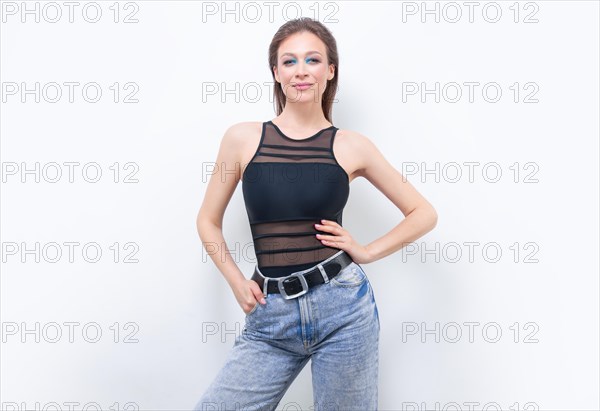 Portrait of a girl in a bodysuit and jeans. Women's underwear concept.
