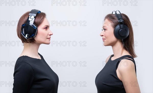 Image of two attractive women with headsets. TV shopping concept.