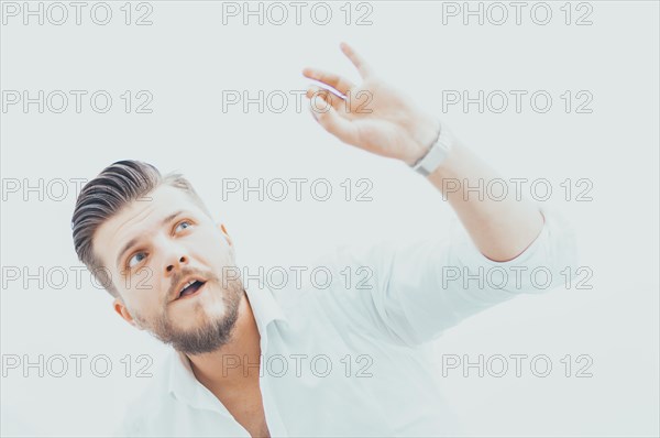 Stylish man in a shirt shows an ok sign right at the camera. The concept of success and support