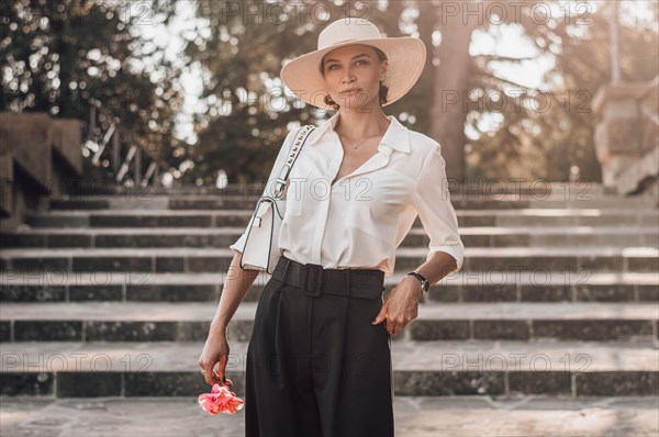 Portrait of a charming girl climbing the stairs to Piazzale Michelangelo in Florence. The concept of tourism