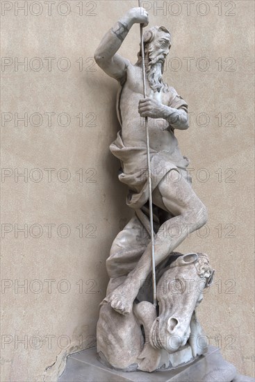 Large male sculpture with horse's head in the garden of Palazzo Reale