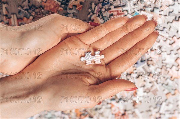 Woman holds puzzle with usa flag. Economic and political concept.