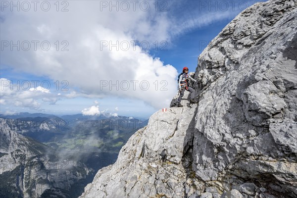 Mountaineer on a narrow rocky mountain path