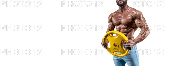 No name sexy muscular man in jeans posing on white background with dumbbell. Bodybuilding and fitness concept.