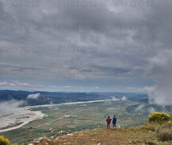 Two visitors marvelling at the view of the Vjosa valley from the Illyrian hilltop settlement of Byllis